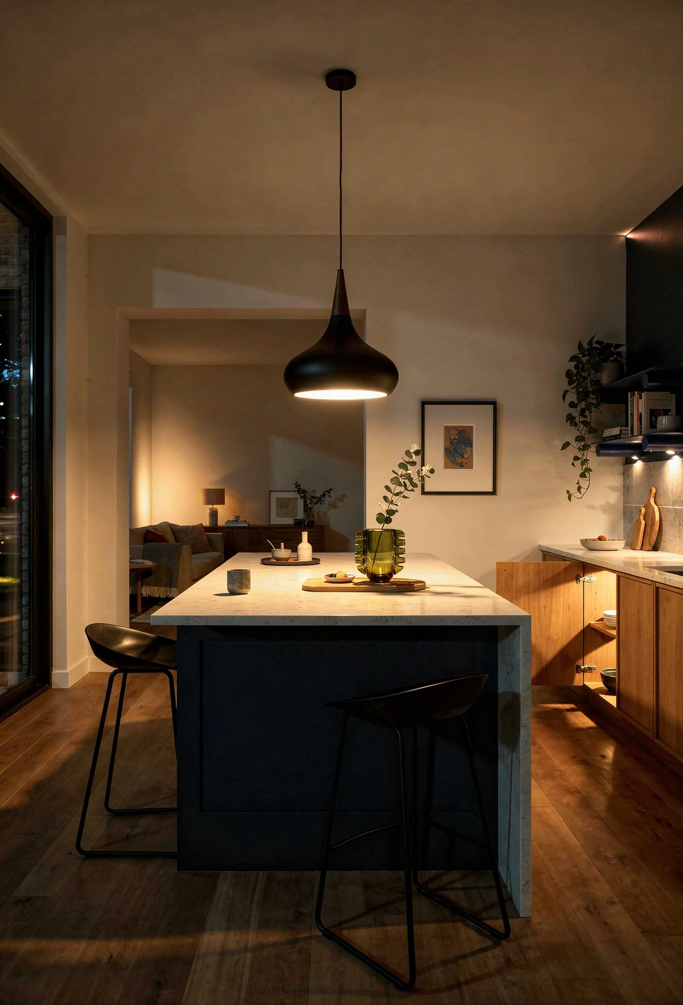 Modern kitchen earthy colors evening lighting featuring black oak pendant over navy island with warm oak cabinets